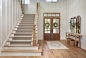 Inspiration for a large farmhouse medium tone wood floor, brown floor and wood wall entryway remodel in Houston with white walls and a dark wood front door