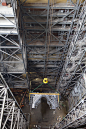 KSC-2015-3643 : A view from high above in the Vehicle Assembly Building at NASA's Kennedy Space Center in Florida, shows a  325-ton crane lifting the first half of the K-level work platforms up for installation in High Bay 3. The platform will be secured
