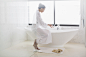 Woman in bathrobe preparing bath by Caia Images on 500px