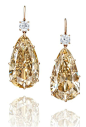 AN EXCLUSIVE PAIR OF COLOURED DIAMOND AND DIAMOND EAR PENDANTS Each suspending a pear-shaped fancy brownish yellow diamond weighing approximately 28.65 and 28.27 carats, surmounted by a cushion-shaped diamond weighing approximately 0.94 carat and an old m