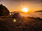 dome tent on mountain top with sun as background photo