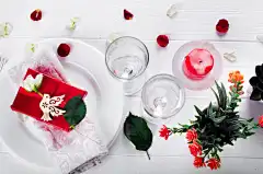 Elegant holiday table setting with red ribbon gift