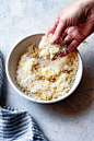 A hand is rubbing the sugar and lemon zest together