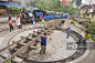 Three boys play on the narrow gauge turntable as a steam train on the Himalayan Mountain Railway approaches Darjeeling Station.创意图片素材 - Lonely Planet