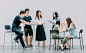 two men and four women meeting in office