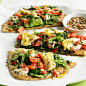 Artichoke Flatbread  --www.bhg.com  Ingredients  4 whole wheat flat bread (naan)  3 tablespoons olive oil  6 cups fresh spinach leaves  6-oz garlic & herb goat cheese,      crumbled  2 6-oz. jar marinated artichoke hearts,     drained and chopped  1 m
