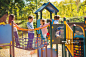 Children playing in the park at playground and communicating.