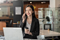 asian-businesswoman-talking-phone-holding-coffee-mug-office_37714-978
