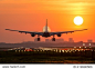 Passenger plane is landing during a wonderful sunrise.