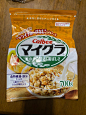 a bag of rice cereal sitting on top of a wooden table next to a spoon