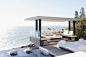 Woman relaxing in cabana overlooking ocean by Caia Images on 500px