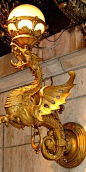 Bronze dragon light fixture at the entrance to the Drake Hotel on Walton Street in Chicago, Illinois.: 