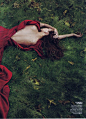 red dress with low back on grass dark romantic and goth - vogue: 