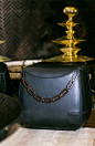 Fendi Casa Cat Ottoman close-up at Holiday House NYC Blue leather combined with bronze chain, dark elegance. Luxury Living Group: 