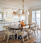 Traditional Neutral Dining Area : In the dining area, Grubbs added custom silk shades to a light fixture from Linden Rose & Co. and suspended it above a custom-sized mahogany table by Rose Tarlow Melrose House. The dining chairs, sporting a custom fin