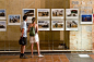 PERPIGNAN, FRANCE - AUGUST 29: Unidentified people watching an exposition at Visa pour l'Image, the premier International Festival of Photojournalism, on August 29, 2011, in Perpignan, France.