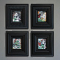 This may contain: four black framed pictures hanging on the wall