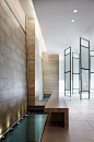 Travertine walls and long water feature, the Yonge & Eglinton condominium in Toronto by Munge Leung architects _