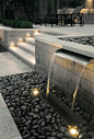 Water feature and exterior lighting designed by Paver Planet, Inc.