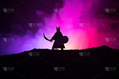 战士用剑勾勒出天空的轮廓。手持剑的中世纪骑士。有选择性的重点
