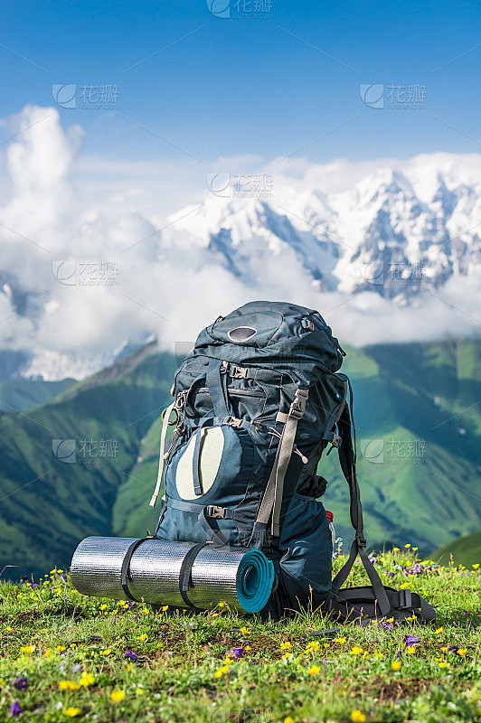 旅游背包和睡袋在山的背景