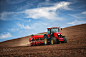 Farmer with tractor seeding crops at field by Valentin Valkov on 500px