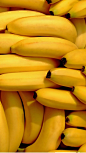 This may contain: bunches of bananas are piled up together