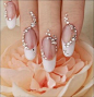 This gorgeous nail art is created with a vertically curved line of rhinestones and pearls combined with a white french manicure. This style can be perfect for brides.