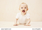 Baby girl lying on floor, studio shot 