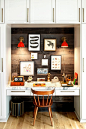 A home-office alcove in the family room is decorated with a variety of artworks and light fixtures from Schoolhouse.: