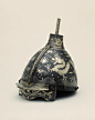 Helmet. 1550-1650, Korea. Iron inlaid with silver. This helmet would have been worn by a military leader of high rank. It also would have been worn with fur ear flaps which unfortunately did not survive. Dragons and other celestial imagery decorate the su