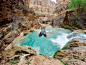 Topless Man Jumping on Body of Water