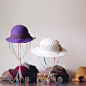 Need a place to hang your hats? Make your own colorful hat stands with just a few inexpensive supplies.