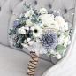 Our grey, navy and cream bouquet is a rustic beauty. This stunning bouquet has a great combination of flowers that work seamlessly with each other. With a mix of silk and wooden flowers this bouquet w