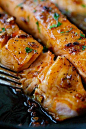 lightly charred Honey garlic salmon flakes with fork, ready to serve.