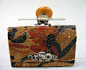 Japanese Kinchaku early 20th century The tabakoire with a tooled leather exterior depicting a phoenix, attached by white metal