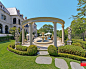 SYMMETRY : Magnificent French Formal Estate in Dallas, Texas featuring limestone, balustrade, tile pool, bluestone, negative edge pool, boxwood parterre, fountains and pavestone driveways. Architecture by Fusch