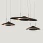 MONK EYES ENSEMBLESet of three saucer-shaped cast bronze pendant ceiling lights by Raphael Navot titled Monk Eyes in the Topographic Memories collection