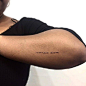 “Carpe Diem” tattoo on the left forearm.