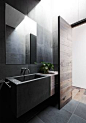 Mink Grey American Oak timber door created by Robson Rak Architects – Malvern. Looks gorgeous in this moody bathroom.