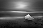 Honorable Mention, Nature: East of Iceland - Glacial ice washes ashore after calving off the Breiðamerkurjökull glacier on Iceland's eastern coast. During the waning light of summer this image was created over the course of a 4 minute exposure while the p