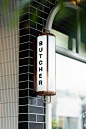 A tiled façade of black and terracotta sets the tone for the new-look retail space of premium Hawksburn butcher Peter Bouchier. Inside, finishes of copper, green mirror and marble bench tops reflect heritage and dedication to quality – characteristics tha