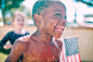 Topless Boy Water Splashes in His Body Smiling for a Close-up Photography during Daytime