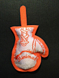 This may contain: an orange and white baseball mitt ornament hanging on a black background with the word minnesota