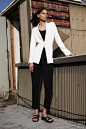 Image may contain Clothing Apparel Suit Coat Overcoat Human Female Person Blazer Jacket Woman and Tuxedo
