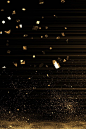 This may contain: gold confetti is flying in the air on a black background