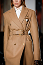 Image may contain Clothing Apparel Overcoat Coat Trench Coat Human and Person