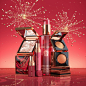 其中可能包括：an assortment of beauty products displayed on a pink background with gold flecks around them