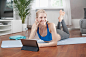 Young woman using digital tablet and listening to music in living room, Bavaria, Germany