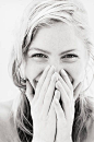 Young woman laughing, hands over mouth, close-up, portrait (B&W) | Photos.com